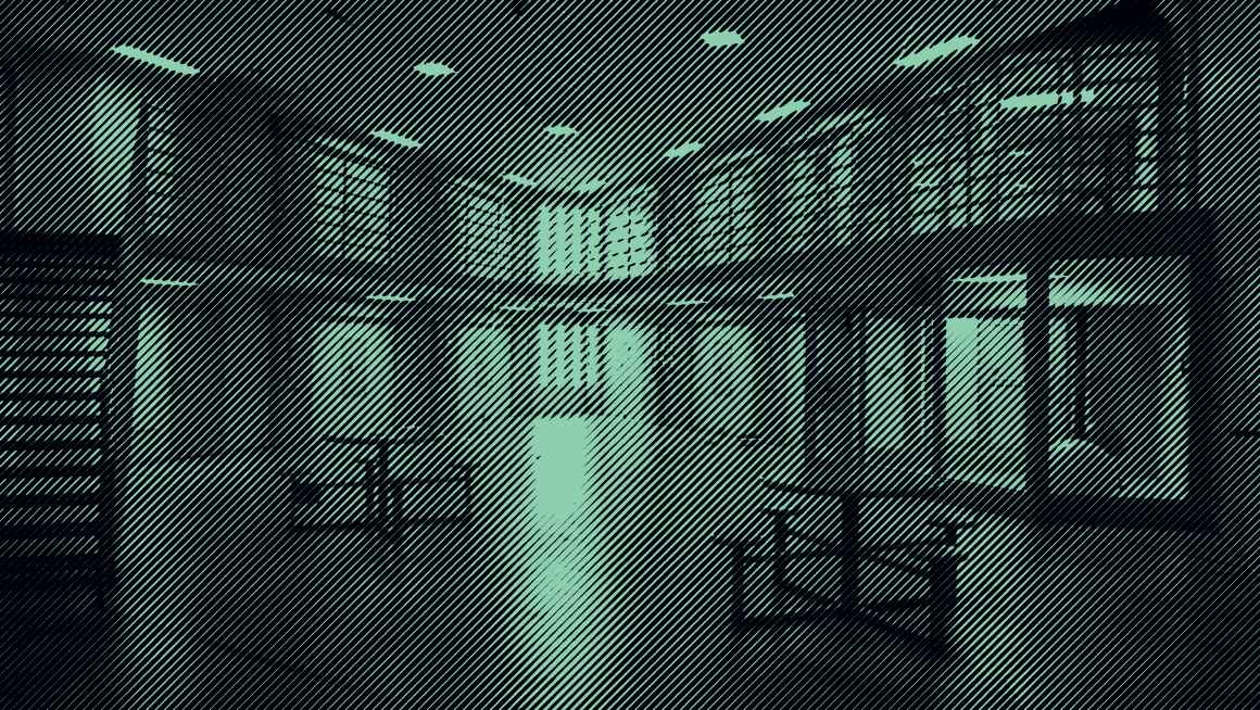 Grainy Green and Black Photo of prison interior