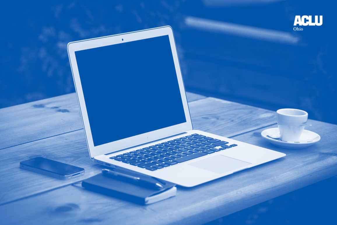 Laptop computer, a cup of coffee, and a small notepad and pen on a desk with blue and white color overlay